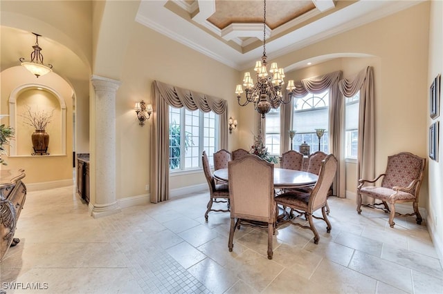 dining area with decorative columns, a high ceiling, ornamental molding, and a chandelier