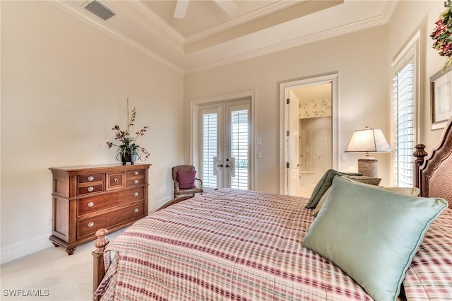 carpeted bedroom featuring ceiling fan, access to outside, ensuite bath, a tray ceiling, and french doors