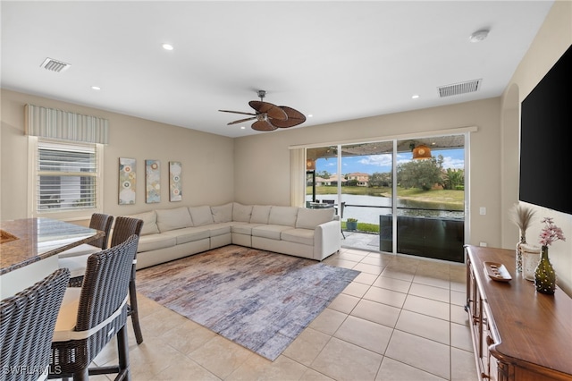 living room featuring light tile patterned floors, a ceiling fan, recessed lighting, and visible vents