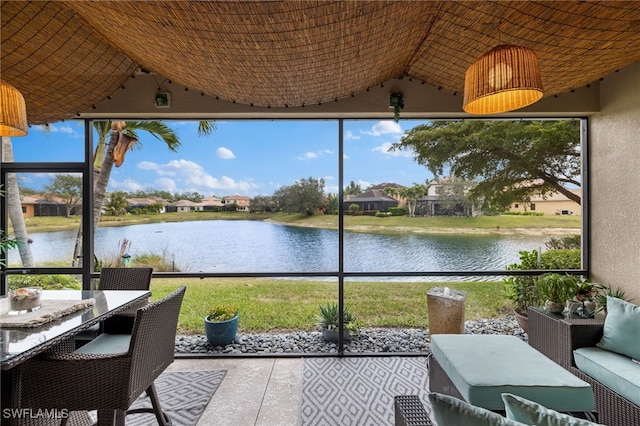 sunroom / solarium with vaulted ceiling, a wealth of natural light, and a water view