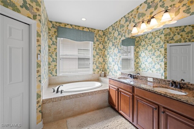 bathroom featuring vanity and a relaxing tiled tub