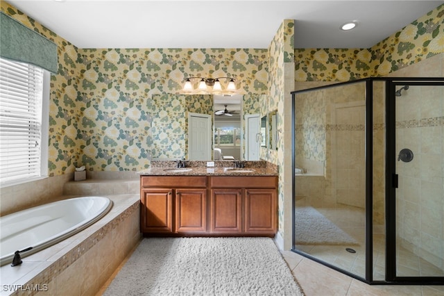 full bathroom featuring a garden tub, a sink, a shower stall, and wallpapered walls