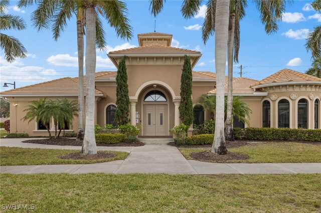 mediterranean / spanish house with a front yard