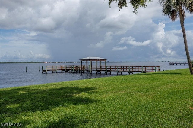 dock area featuring a yard and a water view