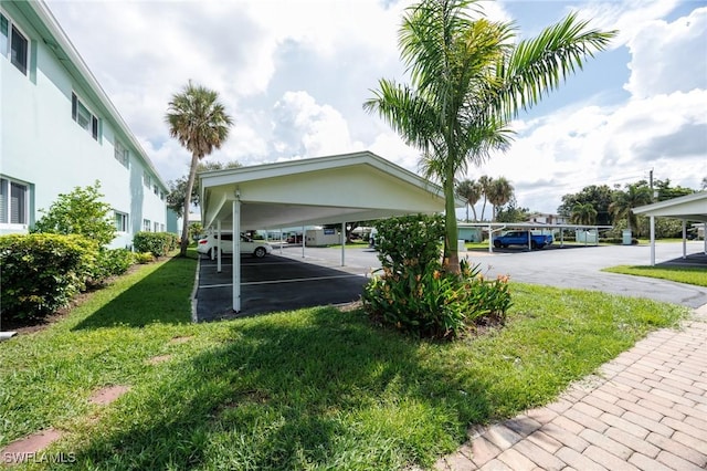 exterior space featuring a yard and a carport