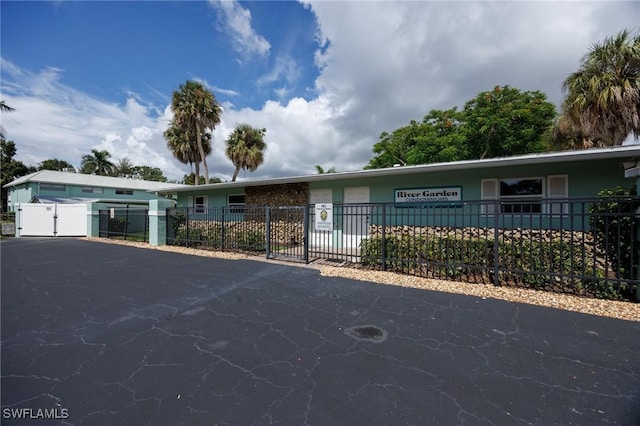 ranch-style house with fence and a gate