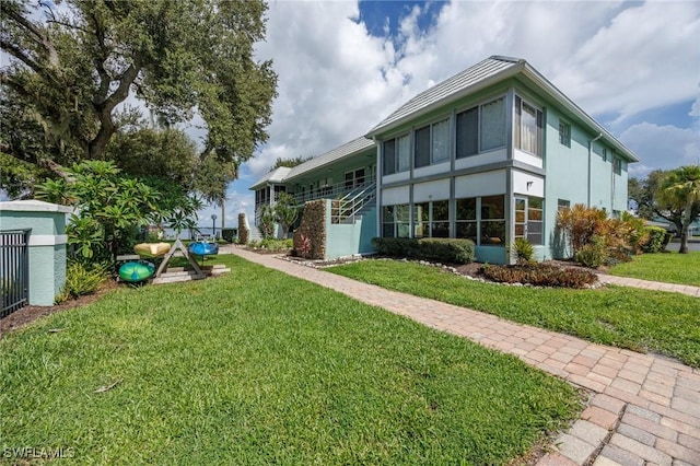 rear view of property with a lawn