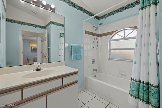 bathroom featuring shower / tub combo, vaulted ceiling, tile patterned floors, and vanity