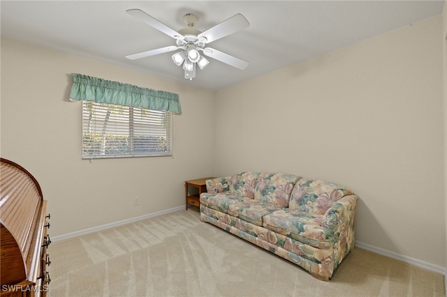 living area with carpet floors and ceiling fan