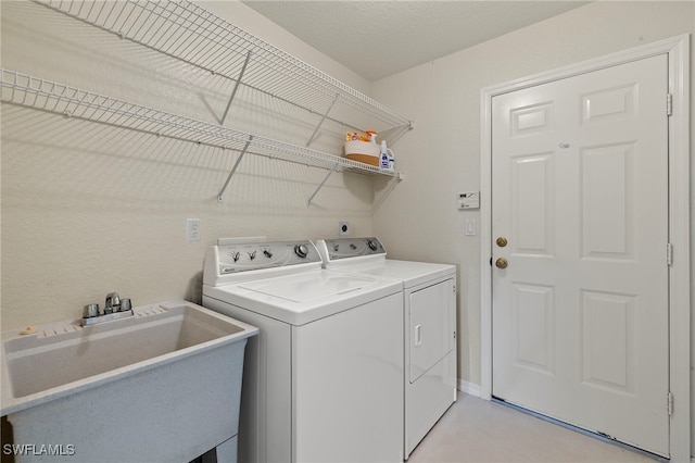 laundry room featuring separate washer and dryer and sink