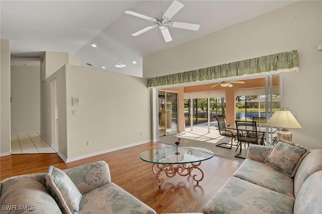 living room with high vaulted ceiling, light wood-type flooring, and ceiling fan