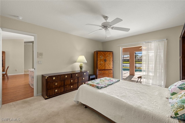 carpeted bedroom featuring ceiling fan and access to outside