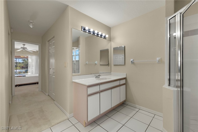 bathroom with ceiling fan, tile patterned floors, an enclosed shower, and vanity