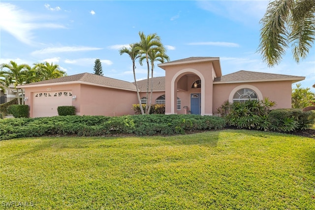 view of front of house with a front yard and a garage