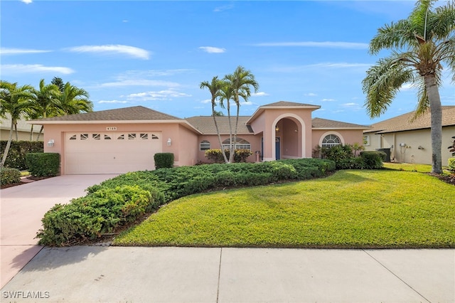 view of front of property with a front lawn and a garage