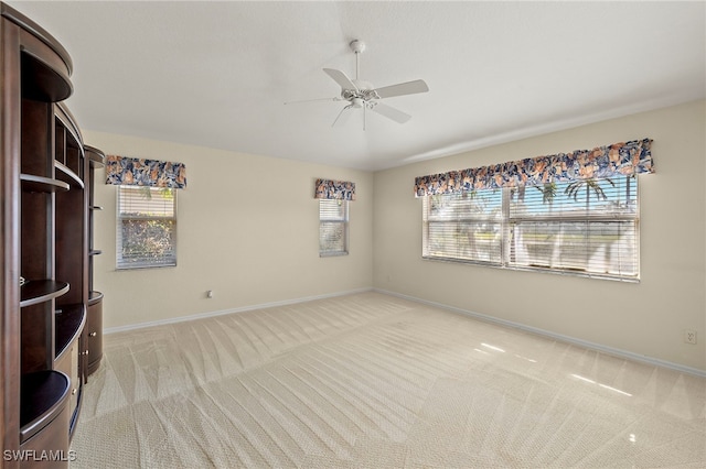 carpeted empty room featuring ceiling fan