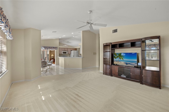 unfurnished living room featuring lofted ceiling, light colored carpet, and ceiling fan