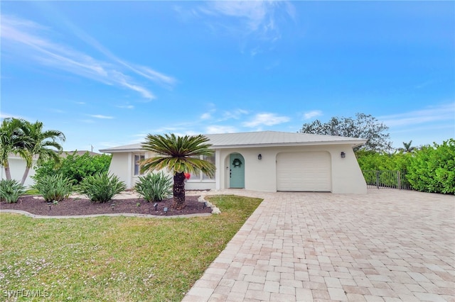 single story home with a garage and a front yard