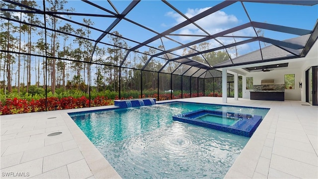 view of swimming pool featuring area for grilling, an in ground hot tub, pool water feature, a lanai, and a patio