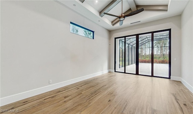 spare room featuring ceiling fan, vaulted ceiling with beams, and light hardwood / wood-style floors