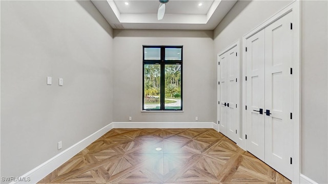 unfurnished bedroom featuring a tray ceiling