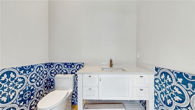 bathroom featuring toilet and vanity