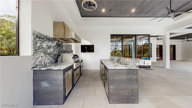 view of patio featuring sink, exterior kitchen, ceiling fan, and area for grilling