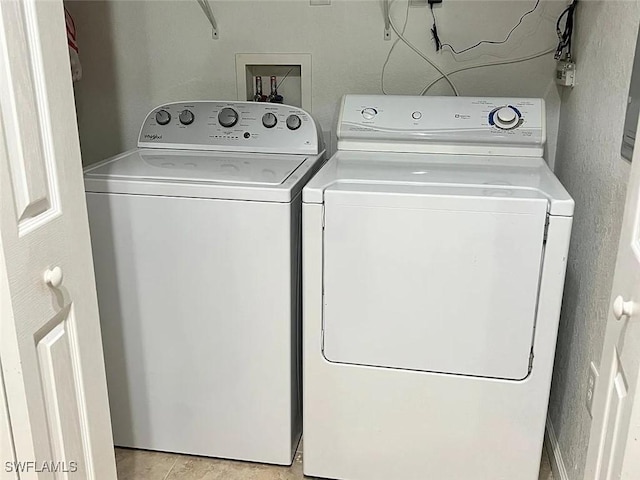 clothes washing area with washing machine and dryer