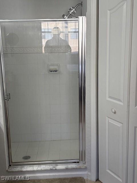 bathroom with a shower with door