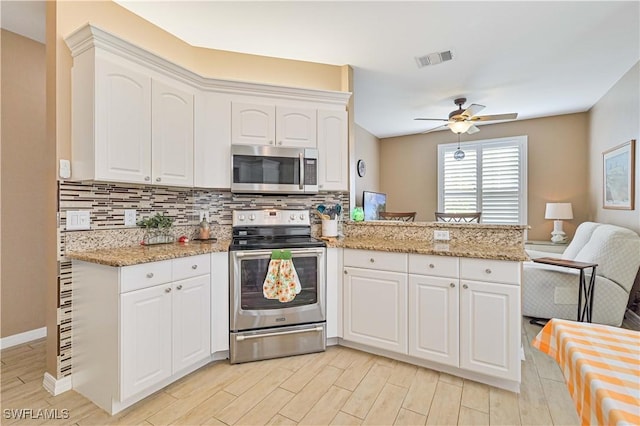 kitchen with stainless steel appliances, white cabinetry, and kitchen peninsula