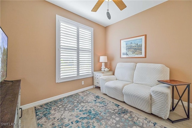 living area with ceiling fan and light hardwood / wood-style floors