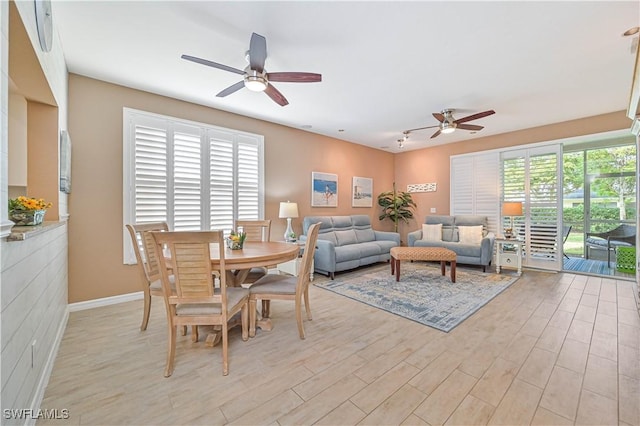 dining space featuring light wood-type flooring and ceiling fan