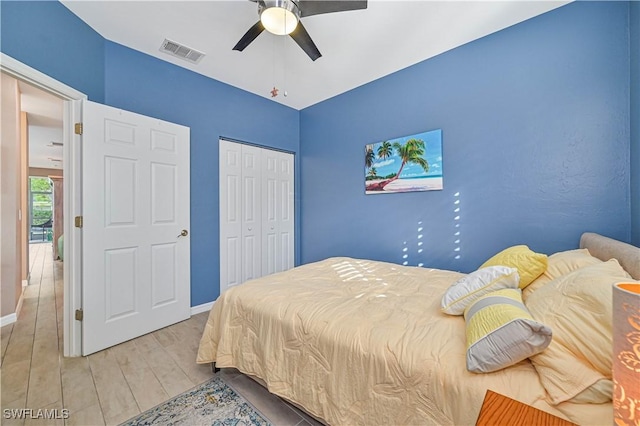 bedroom featuring hardwood / wood-style floors, a closet, and ceiling fan