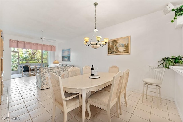 dining area with light tile patterned floors and ceiling fan with notable chandelier