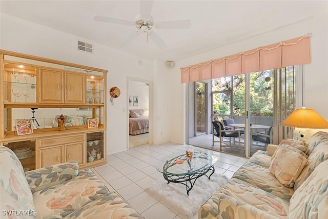 tiled living room featuring ceiling fan