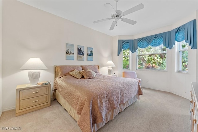 bedroom featuring ceiling fan and light carpet