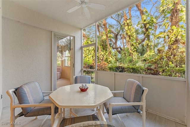 sunroom featuring ceiling fan