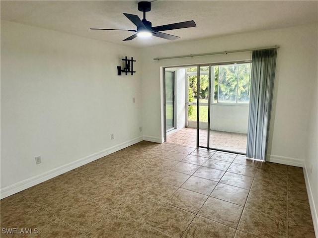 tiled empty room featuring ceiling fan