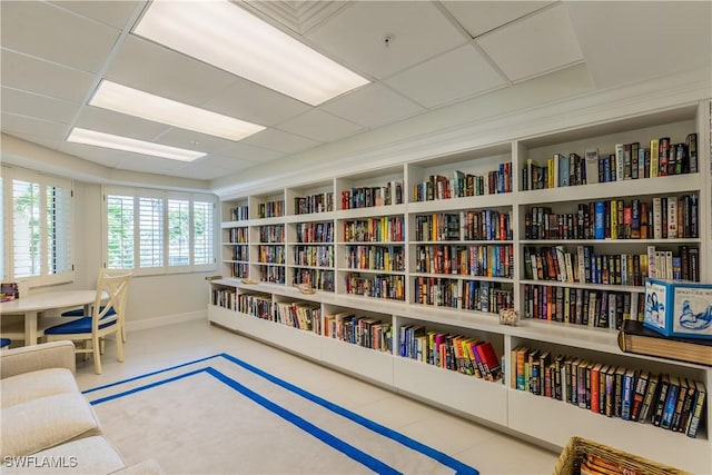 living area with a drop ceiling