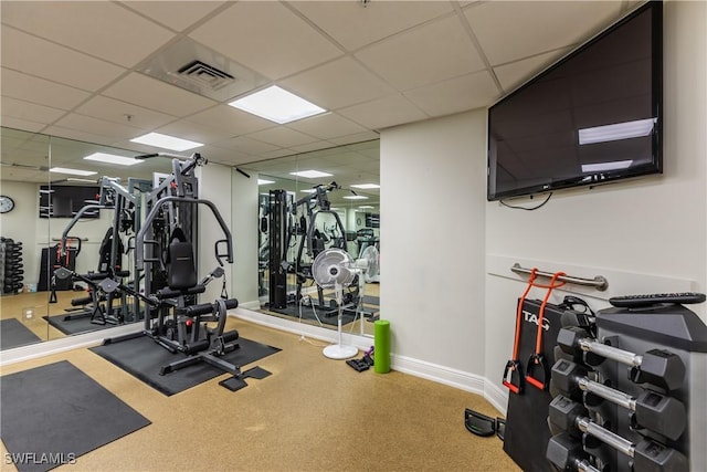 gym featuring a paneled ceiling