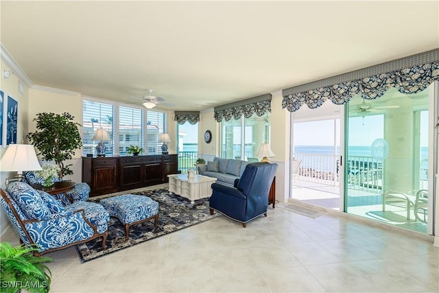 tiled living room with a water view, ceiling fan, and ornamental molding