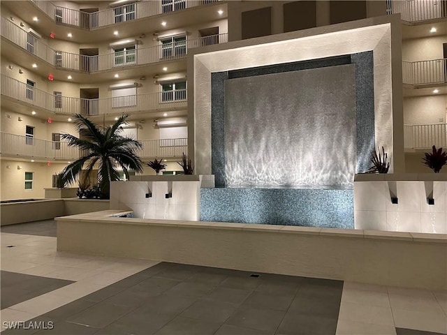 bathroom with tile patterned flooring and a high ceiling