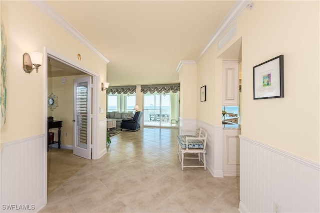 corridor featuring crown molding and light tile patterned floors