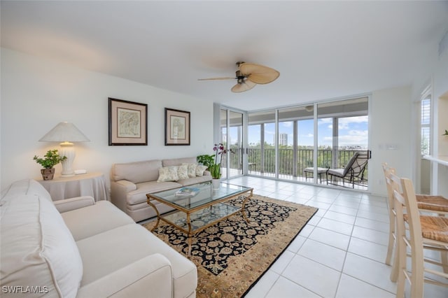 living room featuring tile patterned floors, a ceiling fan, and floor to ceiling windows