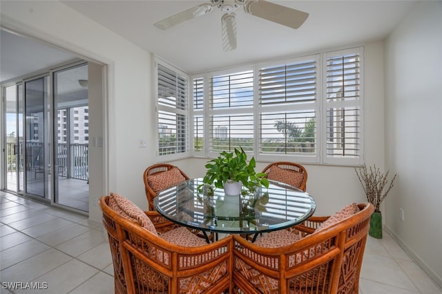 dining room with light tile patterned floors, a ceiling fan, and baseboards