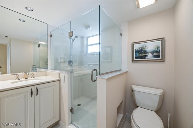 full bathroom with toilet, a stall shower, and vanity