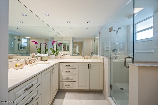 full bath with double vanity, a stall shower, a sink, and tile patterned floors