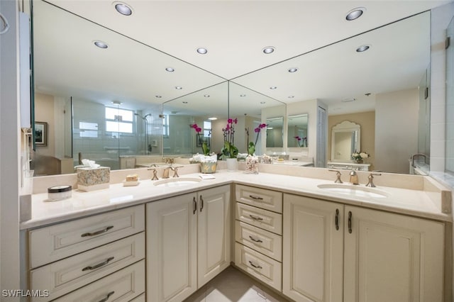 bathroom with a stall shower, a sink, recessed lighting, and double vanity