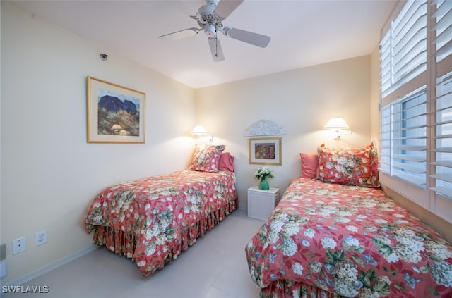 bedroom with ceiling fan and baseboards