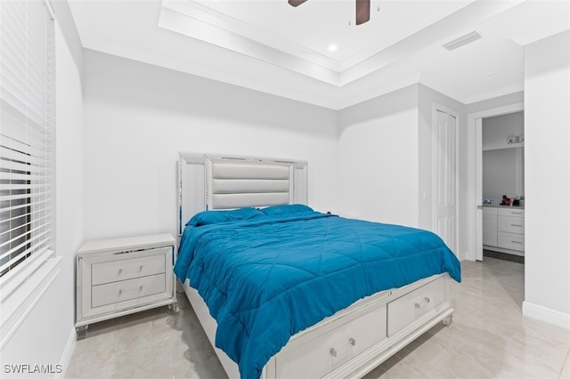 bedroom with ceiling fan, crown molding, and a tray ceiling